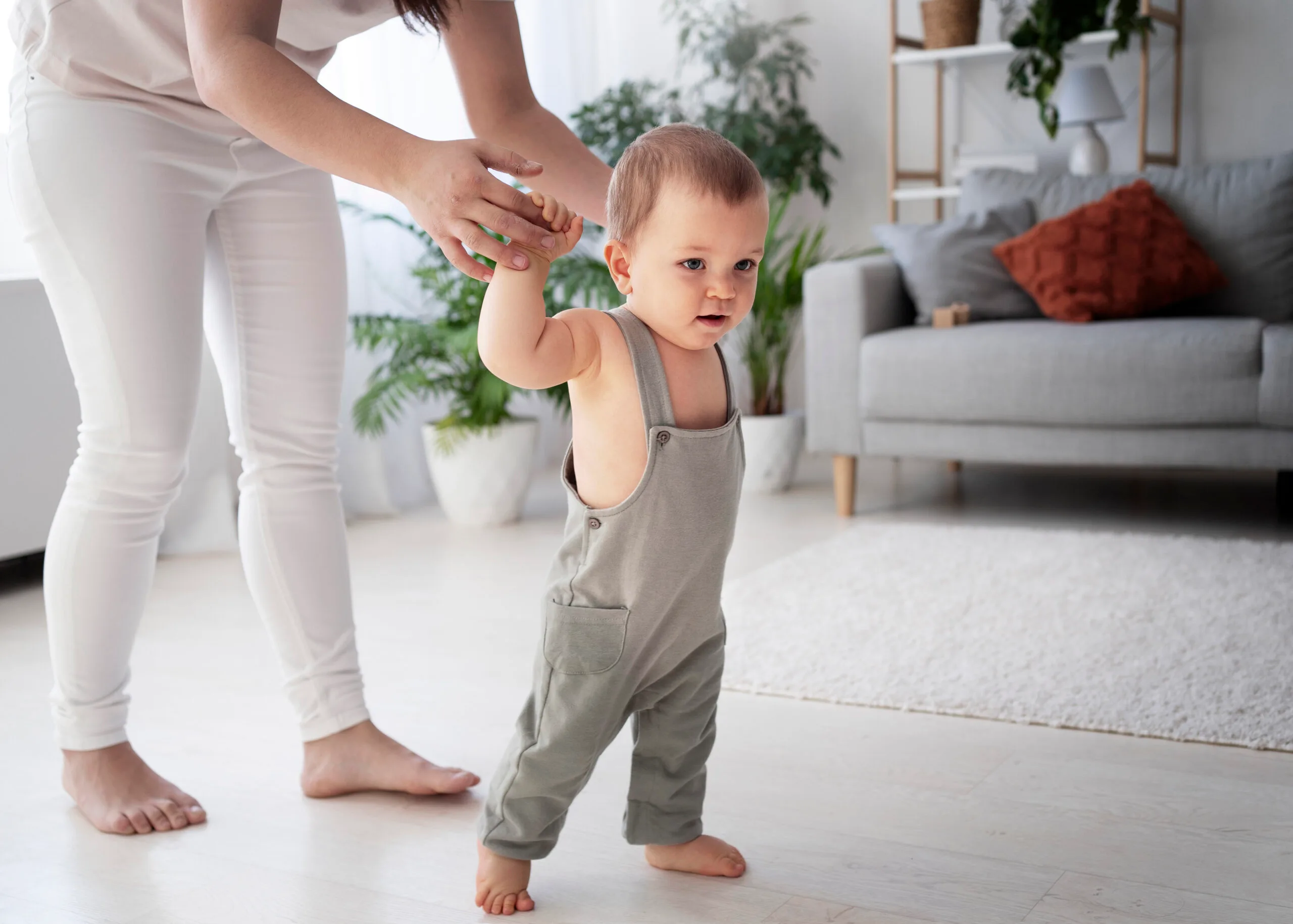 cute baby going their first steps scaled